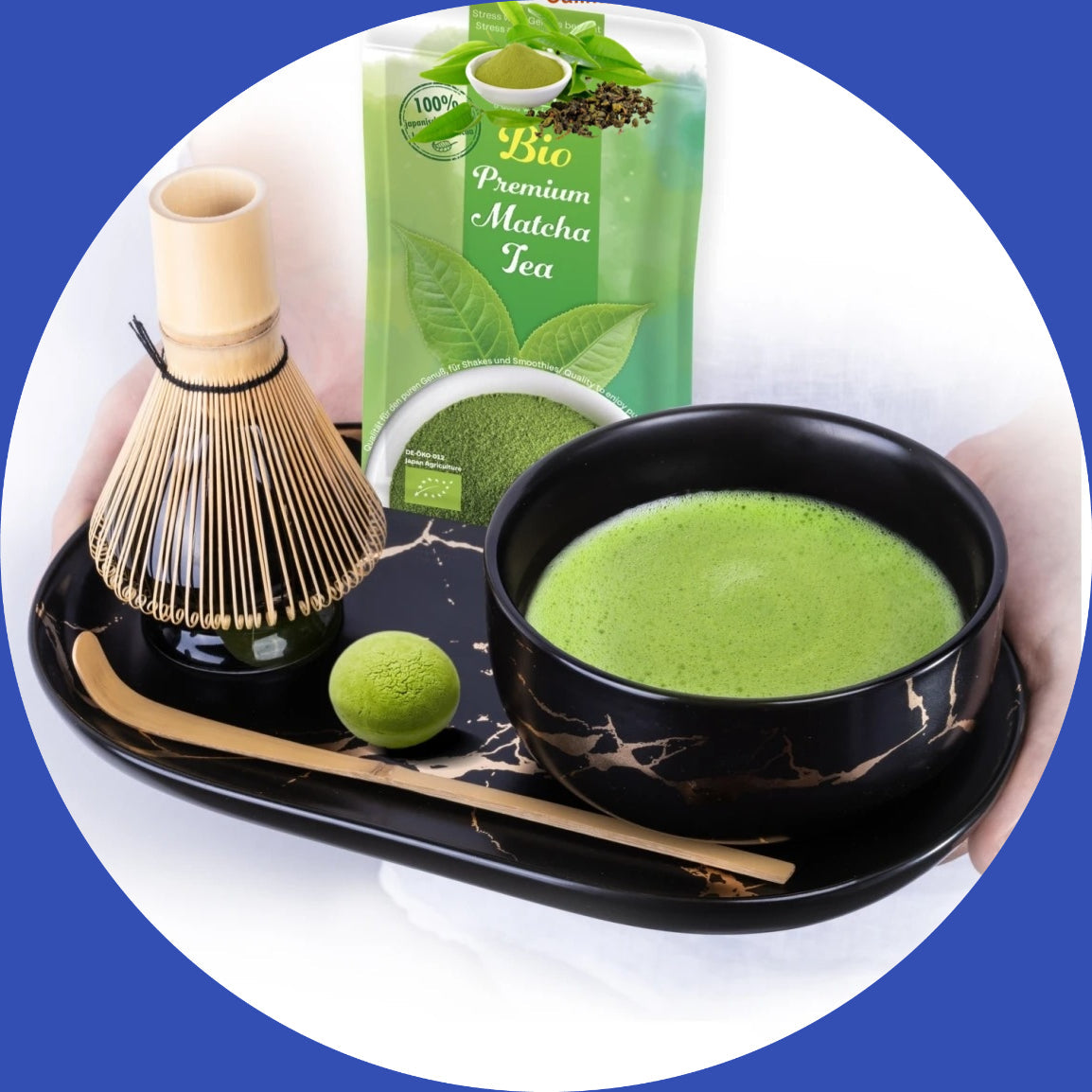 Matcha Tee Set with bamboo whisk, green tea bowl, and premium matcha tea package on a black tray.